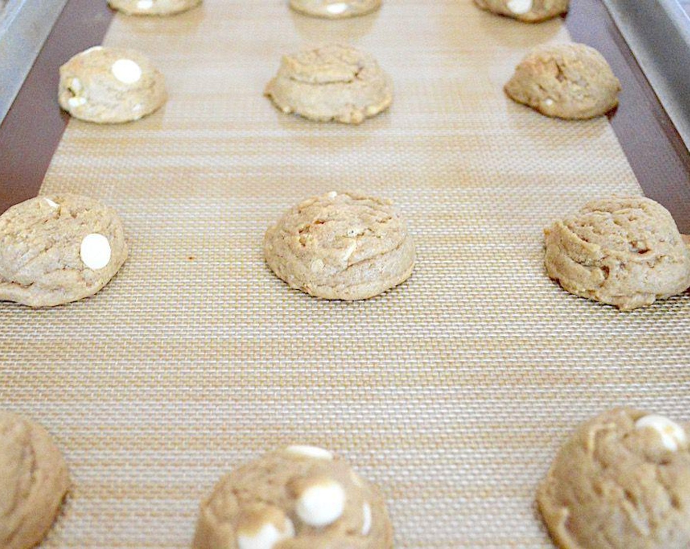 step 4 Use a 1.5 inch scoop to scoop perfect mounds of dough right into the lined baking sheets, filling each tray with 12. Bake them for 10-12 minutes, until golden and just starting to crisp up around the edges. Let them cool for about 10 minutes before transferring them to cooling racks to cool completely.