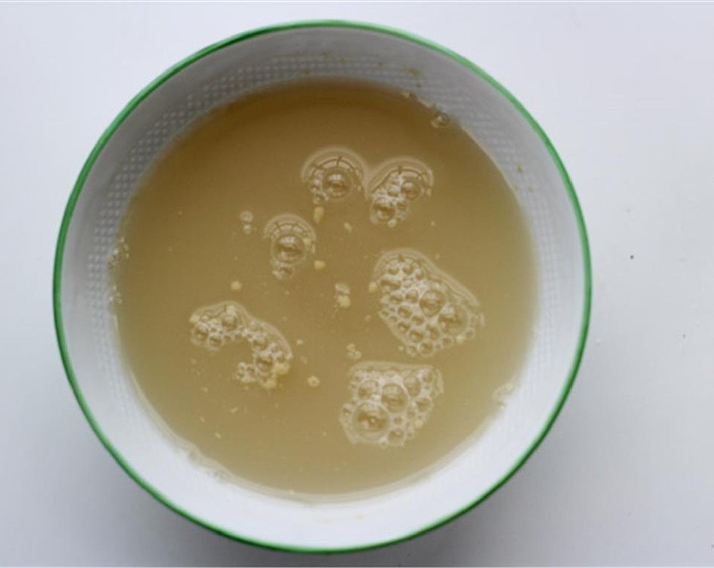 step 2 To make the wrapper, pour the Water (9 oz) and Instant Dry Yeast (1 1/4 tsp) into a bowl of All-Purpose Flour (4 cups) and stir with a chopstick.