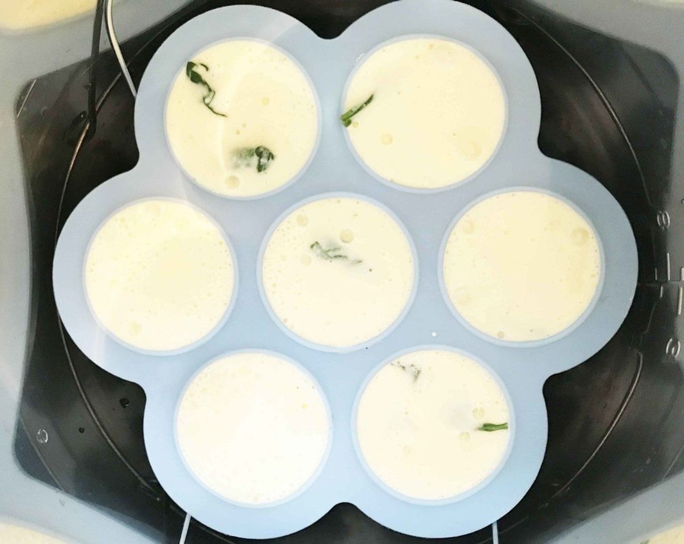 step 9 Place the egg mold onto the metal steamer rack and lower into the pressure cooker.