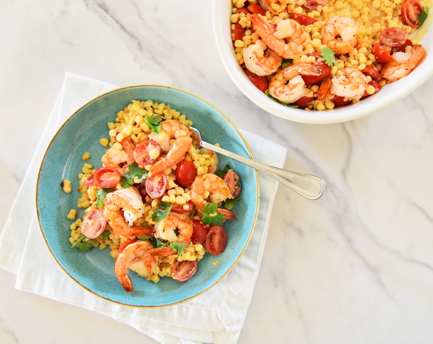 step 11 Pour the corn and tomato mixture into a serving platter. Top the corn salad with the roasted shrimp and garnish with Fresh Cilantro Leaves (to taste).