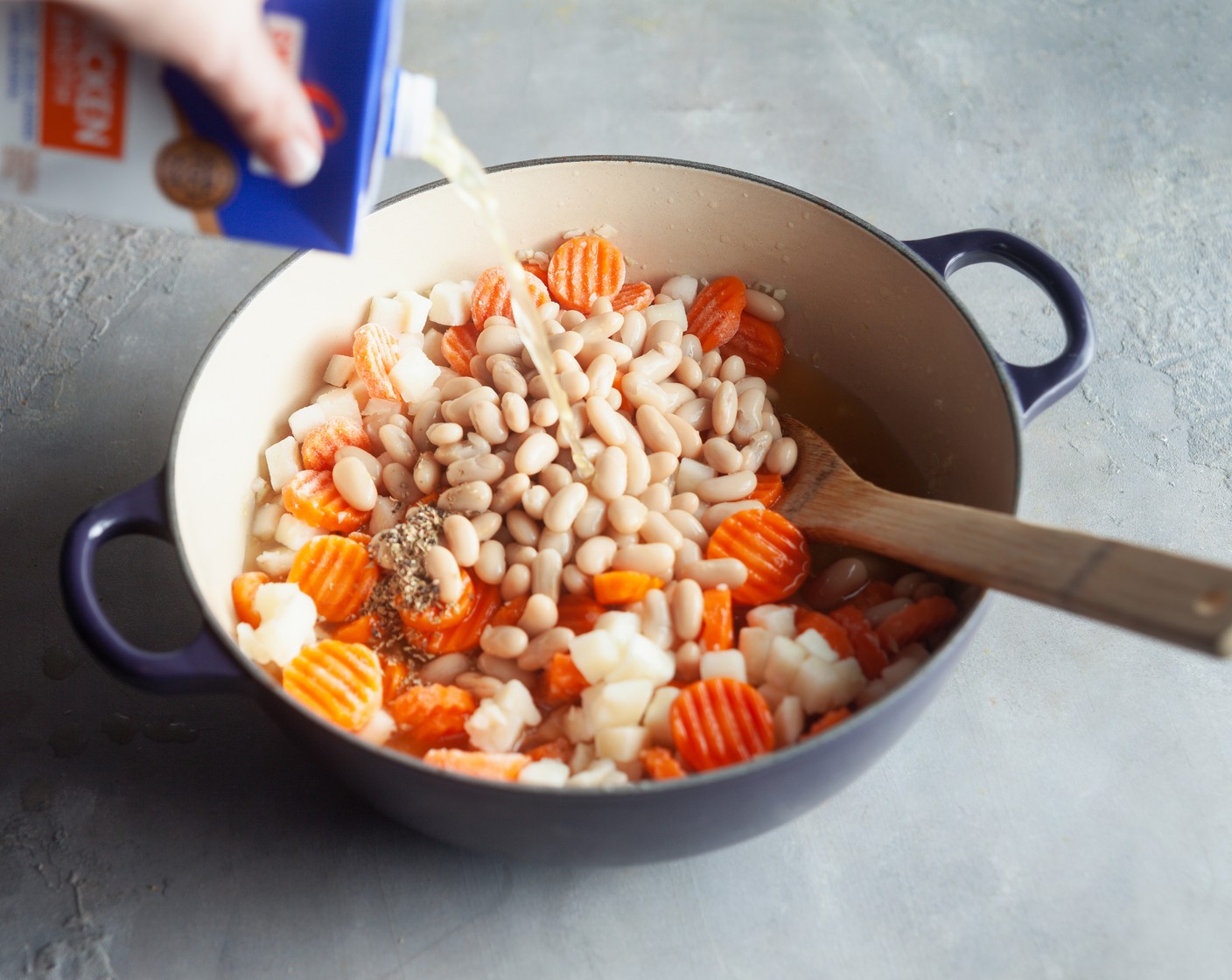 step 2 Stir in the Chicken Broth (1 carton), Water (1 cup), Cannellini White Kidney Beans (2 cans), Frozen Diced Hash Browns (1 pckg), Frozen Carrot (1 pckg), Italian Seasoning (1 tsp), and Ground Black Pepper (1/4 tsp). Simmer for 15 minutes, until the vegetables are soft and the soup is heated through.