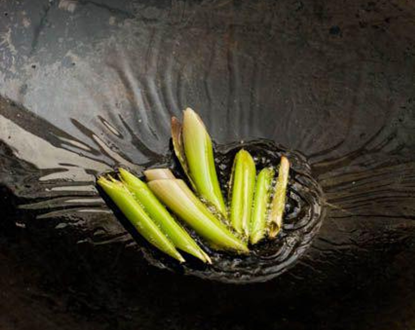 step 4 Heat Cooking Oil (3 Tbsp) in a wok over medium-high heat. Add the lLemongrass (2 stalks) to the wok and stir-fry until slightly charred at the edges.