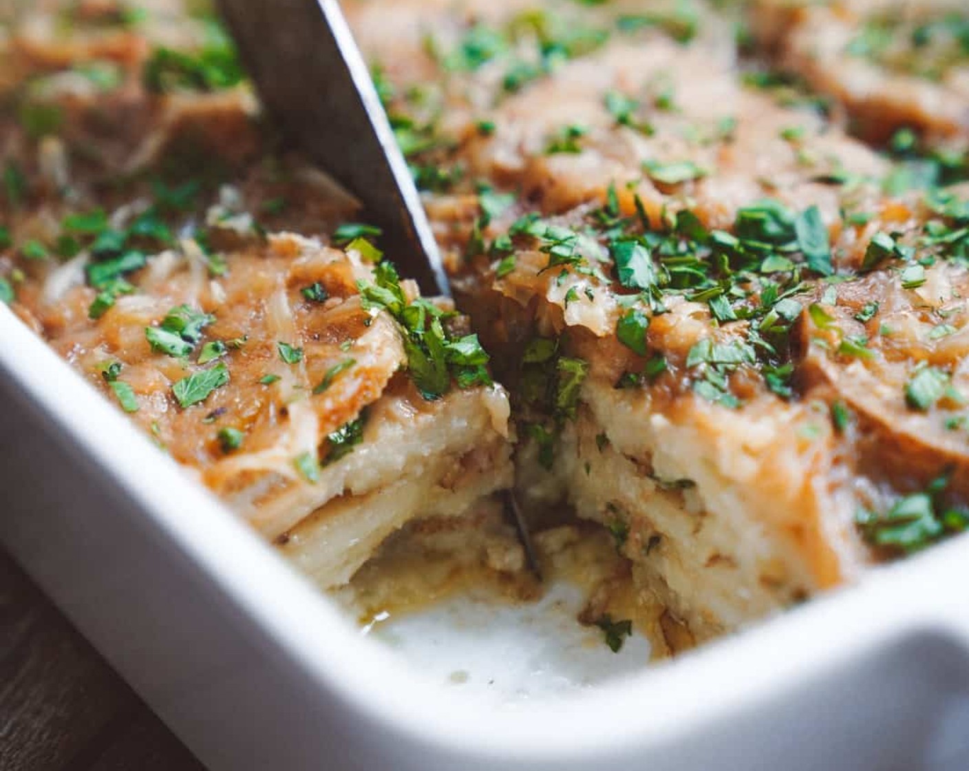 step 7 Stir again just before pouring over your potato layers. Top off with some Vegan Parmesan Cheese (1/3 cup) and cover with tin foil. Cook covered for 45 minutes and under covered for around 10 minutes. To add that golden brown effect you can broil just before serving!