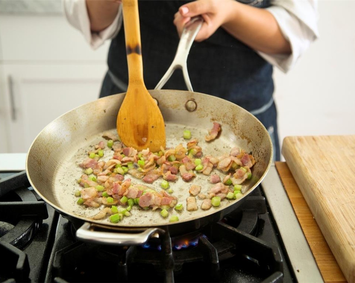 step 11 In the same large saute pan over medium heat, add Olive Oil (1 Tbsp). Add bacon and celery and cook for four minutes until bacon is crisp and celery is softened.