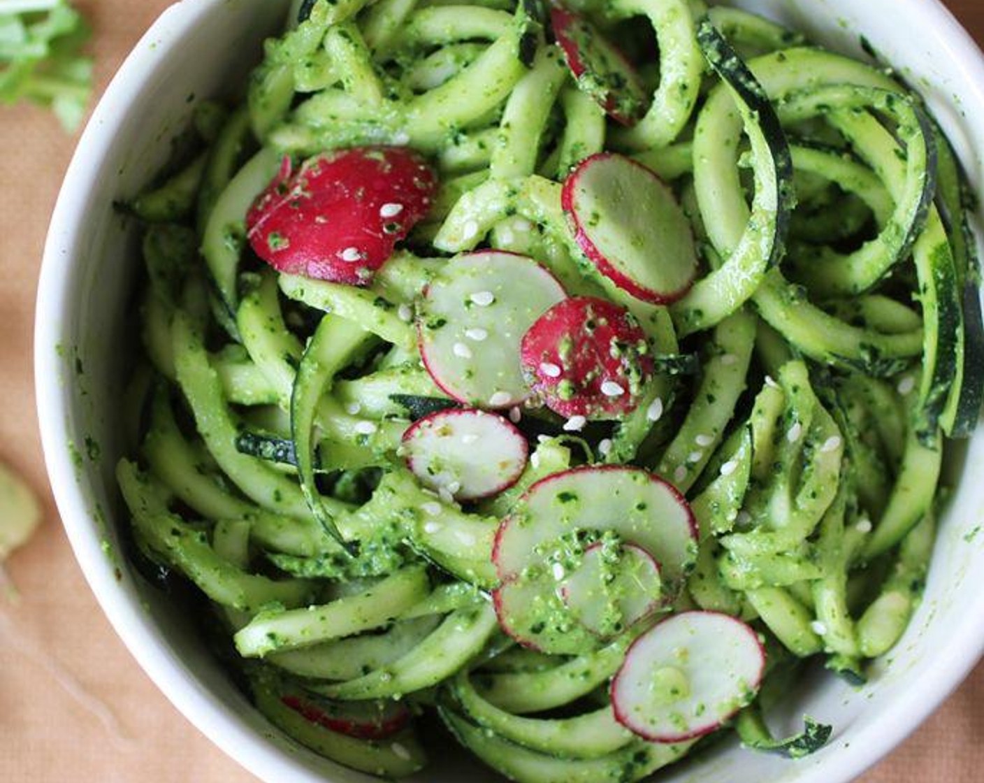 step 3 Toss the zucchini into the pesto, top with Radish (1 bunch) and Sesame Seeds (to taste), and enjoy!