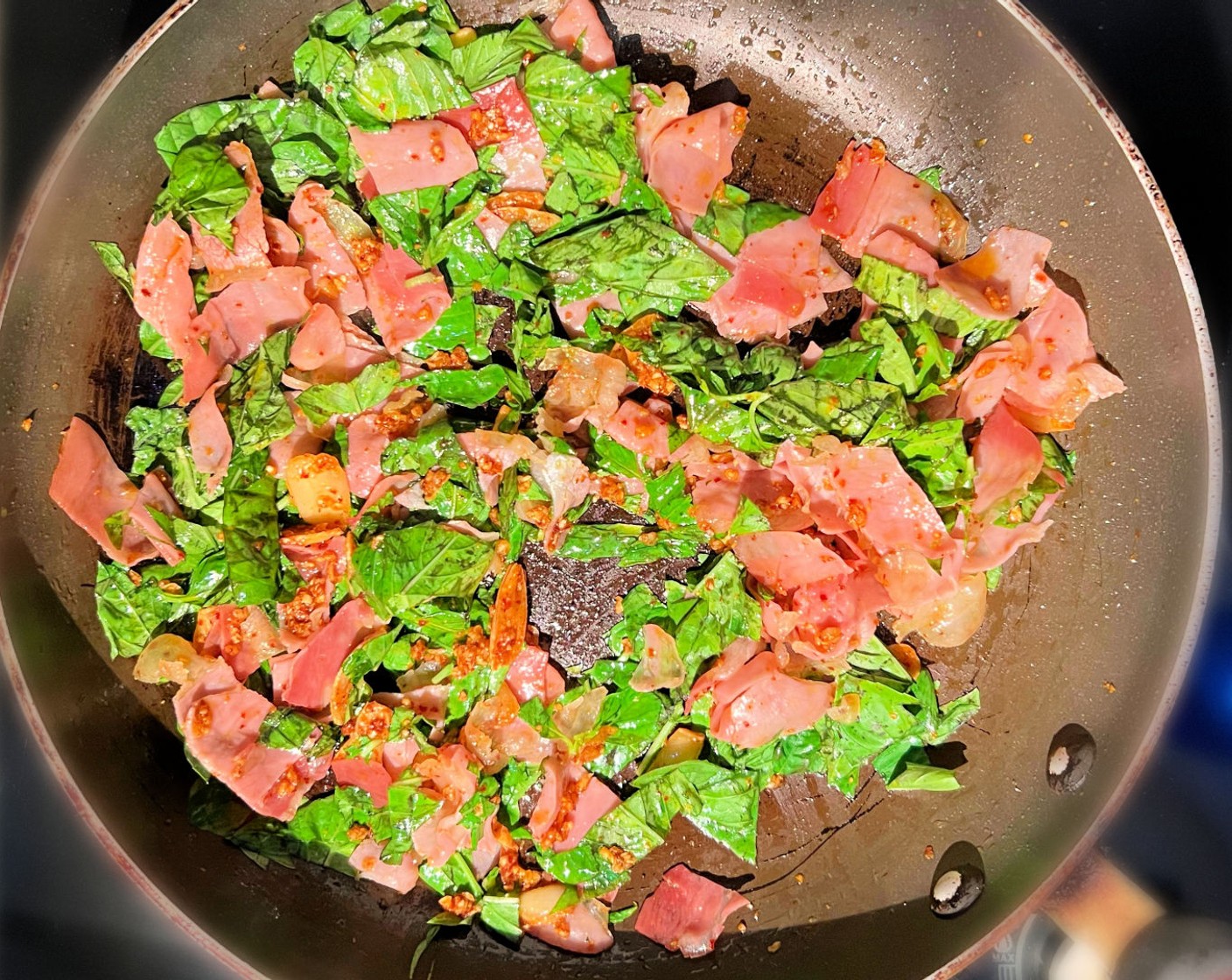 step 5 Add the minced Garlic (8 cloves) and sautée. Then add the Crushed Red Pepper Flakes (1 Tbsp), a Tbsp of Olive Oil (1 Tbsp), and the Prosciutto (6 oz). Stir for about a minute.