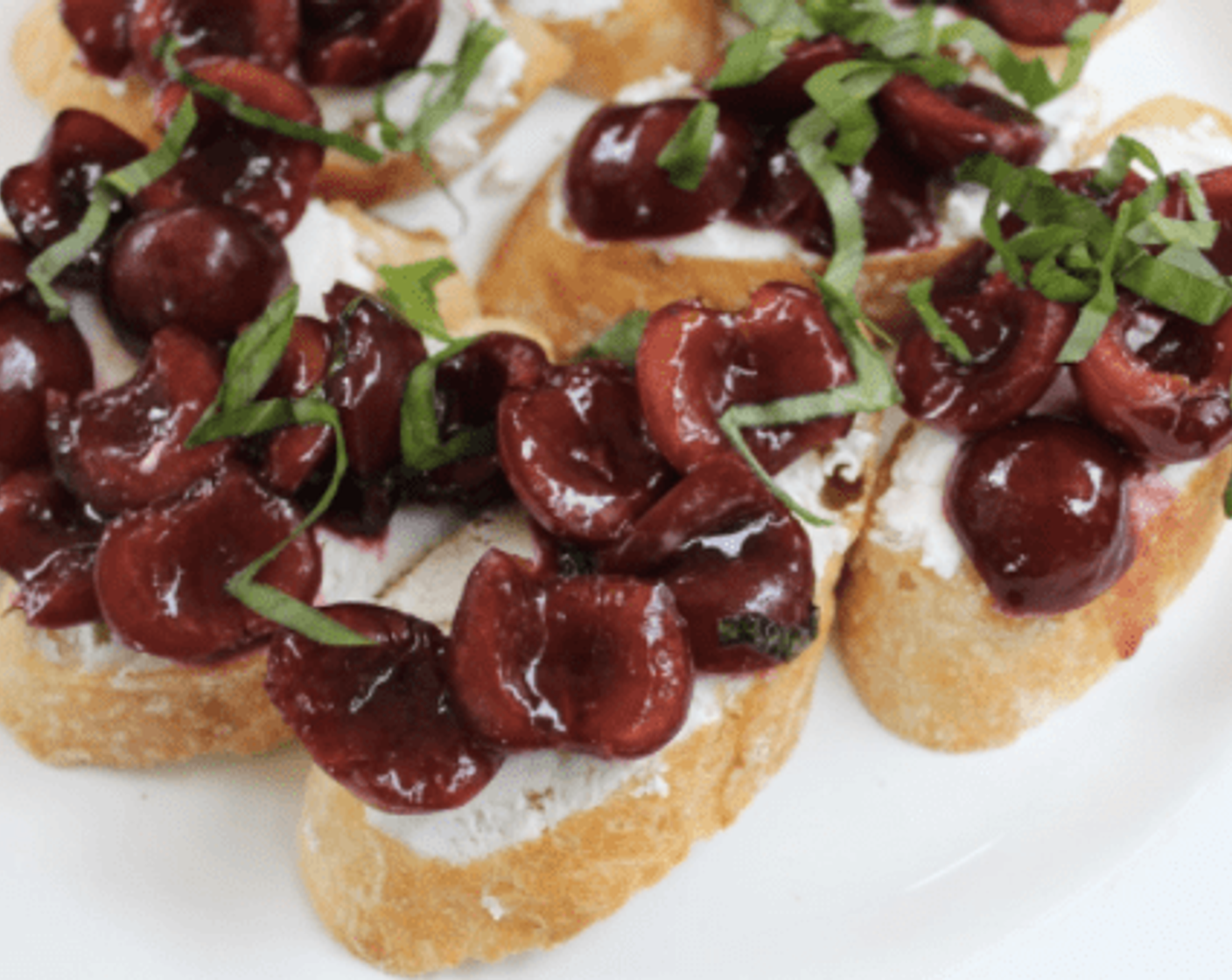 step 5 To assemble the crostini, spread a layer of Goat Cheese (1 cup) onto each baguette slice, then top with a spoonful of cooked cherries. Sprinkle the remaining Fresh Basil (2 Tbsp) over the crostini and serve immediately.