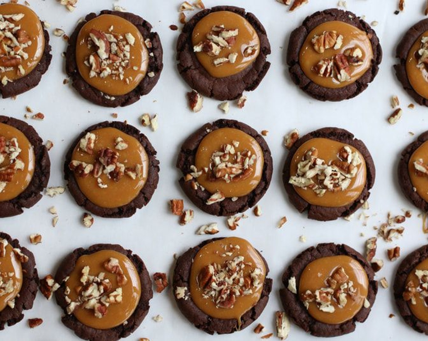 step 8 Immediately spoon about 1 tablespoon of caramel sauce into the center of each brownie cookie; sprinkle with Pecans (1 cup) and cool for 1 hour.