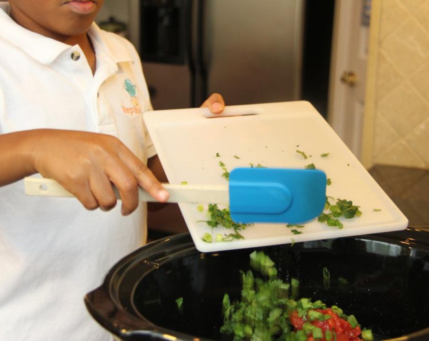 step 3 Add Low-Sodium Chicken Broth (1 2/3 cups), Frozen Corn Kernels (1 cup), Canned Black Beans (2 1/3 cups), cilantro, green onions, tomatoes, Ground Cumin (1 tsp), and seasoned chicken to a slow cooker. Cook on high for 6 hours.