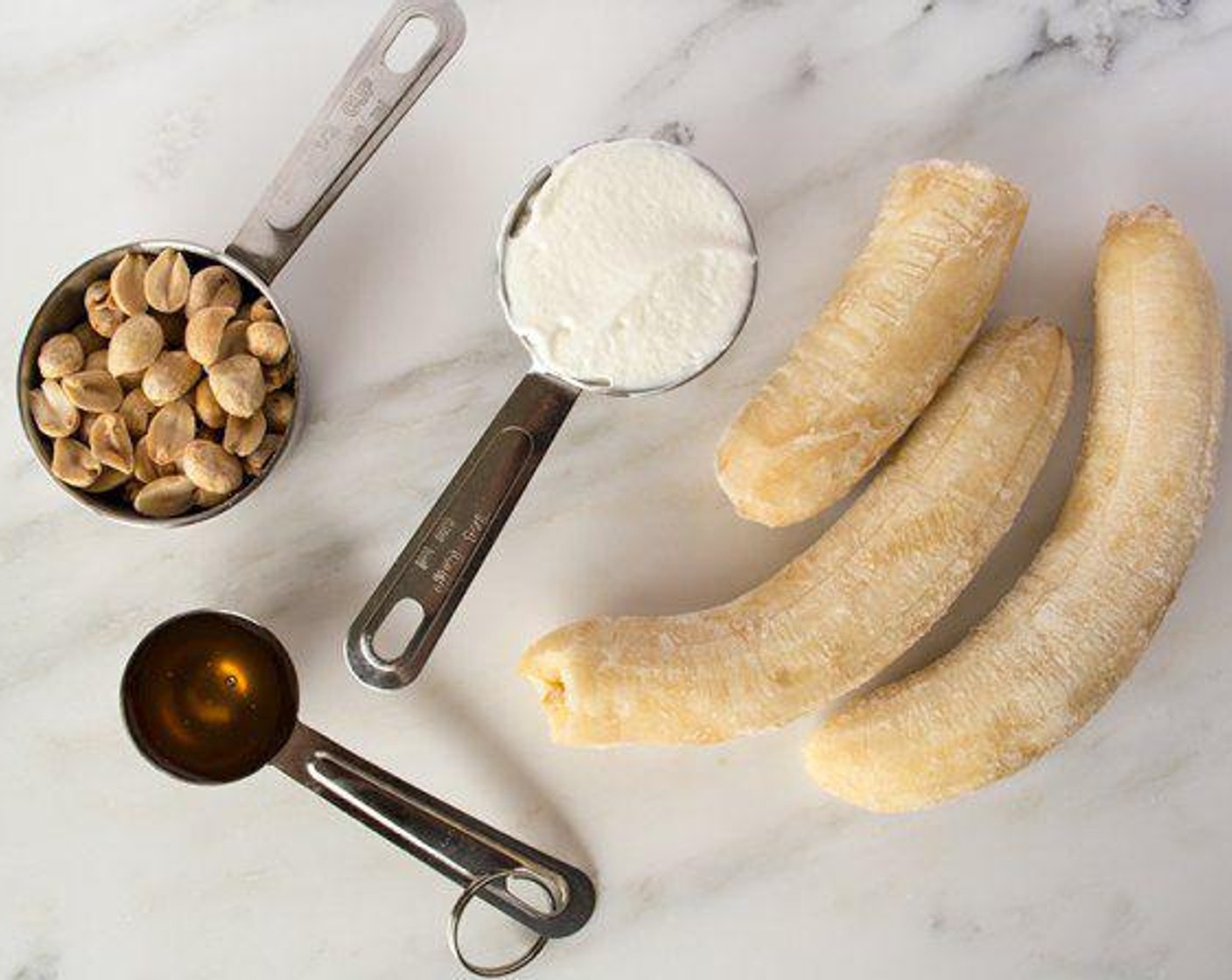 step 2 With ground peanuts still in food processor, add Bananas (2 1/2), Greek Yogurt (4 Tbsp), Honey (1 Tbsp), Vanilla Extract (1/4 tsp) and Stevia (1/4 tsp) blend until smooth and creamy.