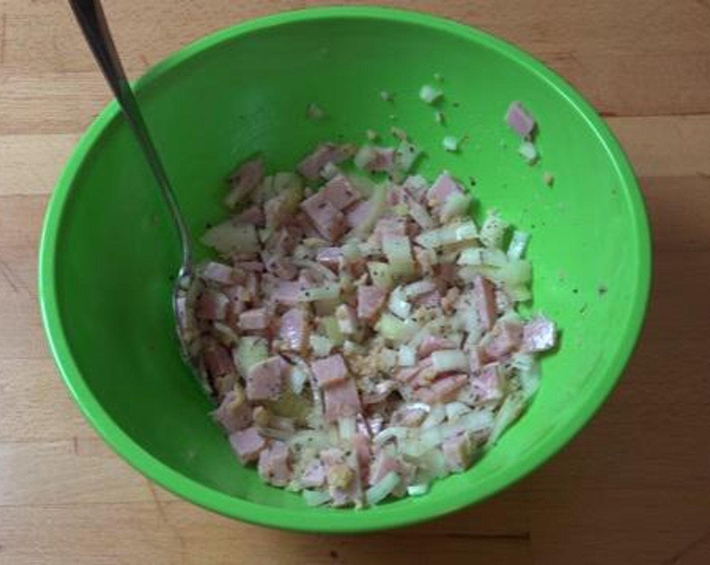 step 1 Into a mixing bowl, add the Yellow Onion (1), crushed Garlic (2 cloves), Dried Mixed Herbs (1 Tbsp), Short Cut Rindless Bacon Slices (4), Olive Oil (2 Tbsp), Salt (to taste), and Ground Black Pepper (to taste). Give that a good mix together.
