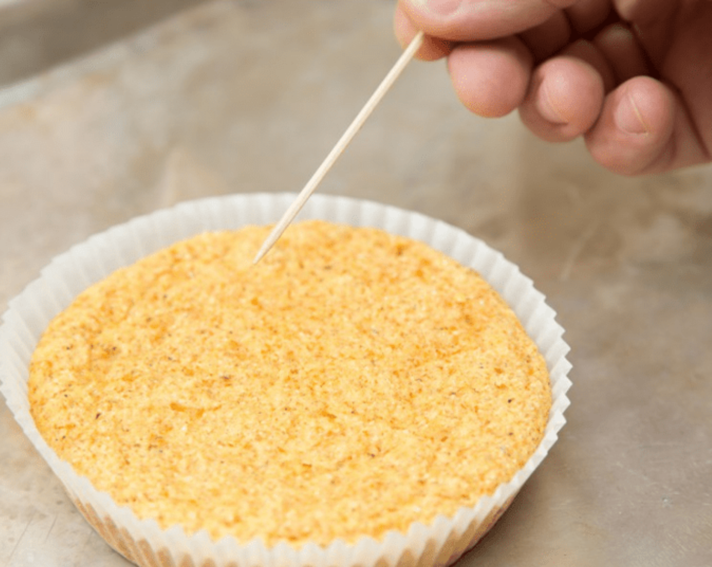 step 10 Place muffin baking cup included in your PeachDish box in a heavy baking pan. Fill with cornbread batter. Bake 15-20 minutes, or until golden brown on top and a toothpick inserted in the center comes out clean.