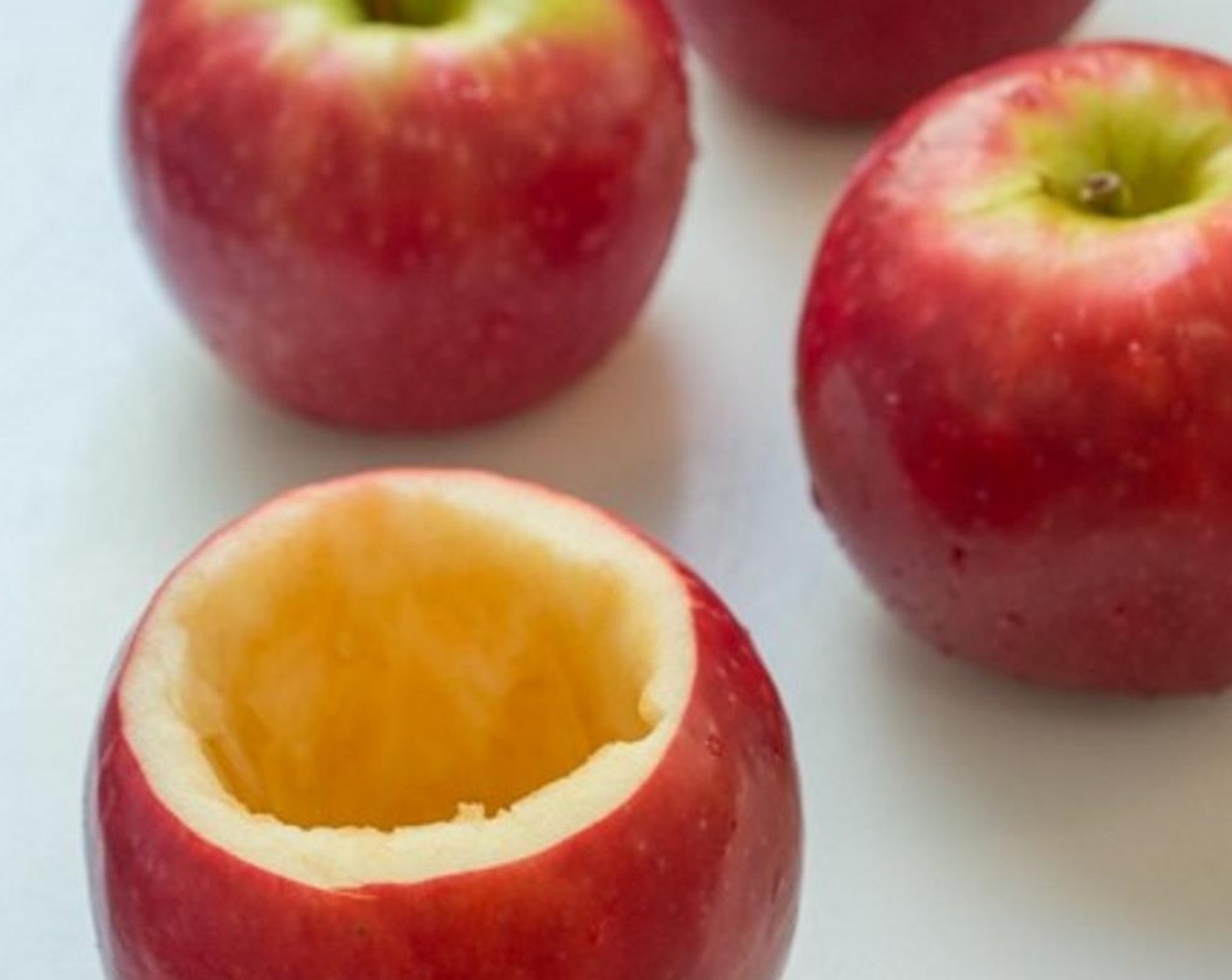 step 5 Next, cut the tops off Red Apples (6), then remove as much of the core as you can. Don't remove too much of the red apple pulp. Keep at least a quarter inch of pulp from the red apple skin.