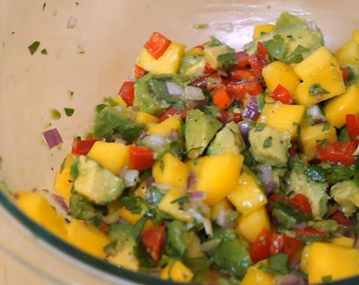 step 2 In a different bowl, add the Mango (1), Red Bell Pepper (1/3 cup), Red Onion (1/4 cup), Avocado (1), Jalapeño Peppers (to taste) and Fresh Cilantro (1/4 cup). Juice the Limes (2) over the top and add the Salt (1/2 tsp) and Ground Black Pepper (to taste). Mix thoroughly.