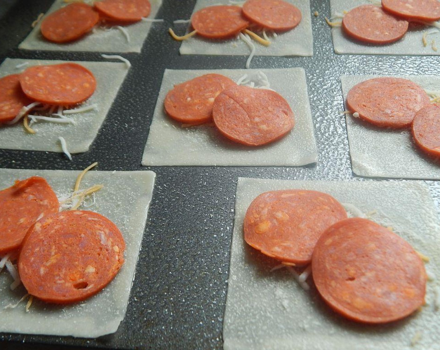 step 4 Add two of the Pepperoni Slice (1 pckg) on top of each wonton wrapper.