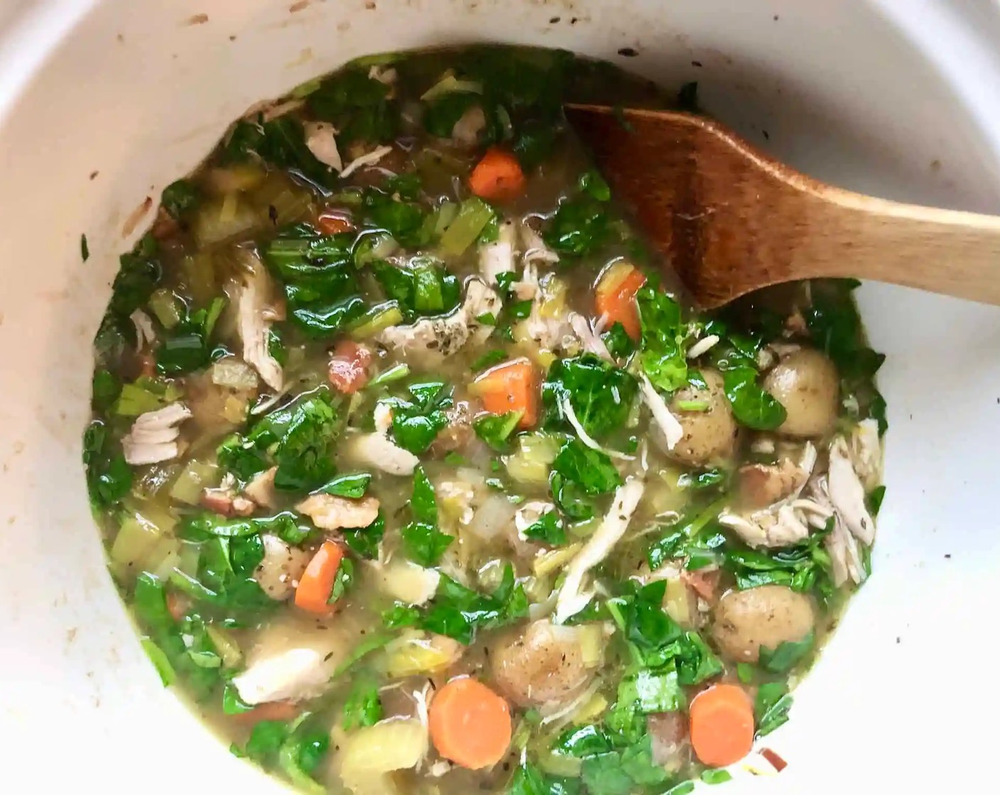 step 8 Return the chicken to the slow cooker, add the Fresh Baby Spinach (2 cups), stirring until the spinach wilts.