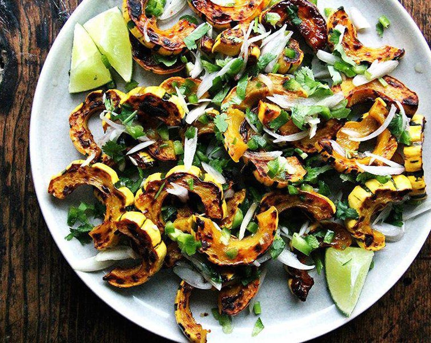 step 6 Arrange the squash slices on a platter. Scatter the macerated shallots and jalapeño over top. Scatter the Fresh Cilantro (1 bunch) over the top. Serve with the rest of the Lime (1/2) sliced into wedges on the side.