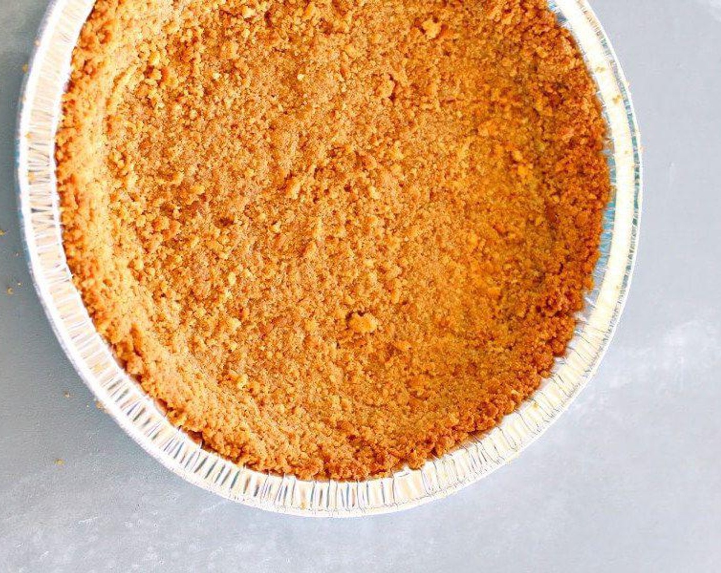 step 3 Pour the biscuit crumbs into a mixing bowl and stir in the Butter (1/2 cup) (plus 1 tablespoon) until well combined. Press down into the base and up the sides of the pie dish.