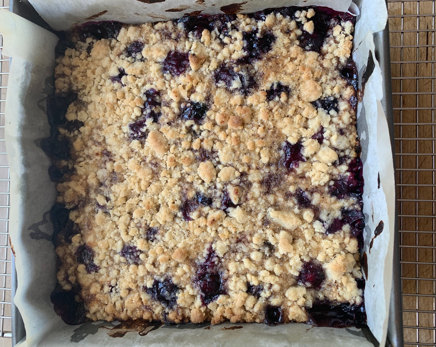 step 5 Using your hands sprinkle the remaining batter over the top of the berry mixture. Lightly press the crumb mixture into the pan. Sprinkle the Raw Sugar (1 Tbsp) evenly over the top before baking.