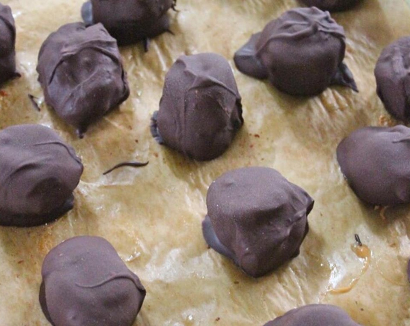 step 4 Take out the frozen banana sandwiches, and dip them in the chocolate. I used a fork for this step. Place dark chocolate covered banana slices back on baking tray and let sit until chocolate sets.