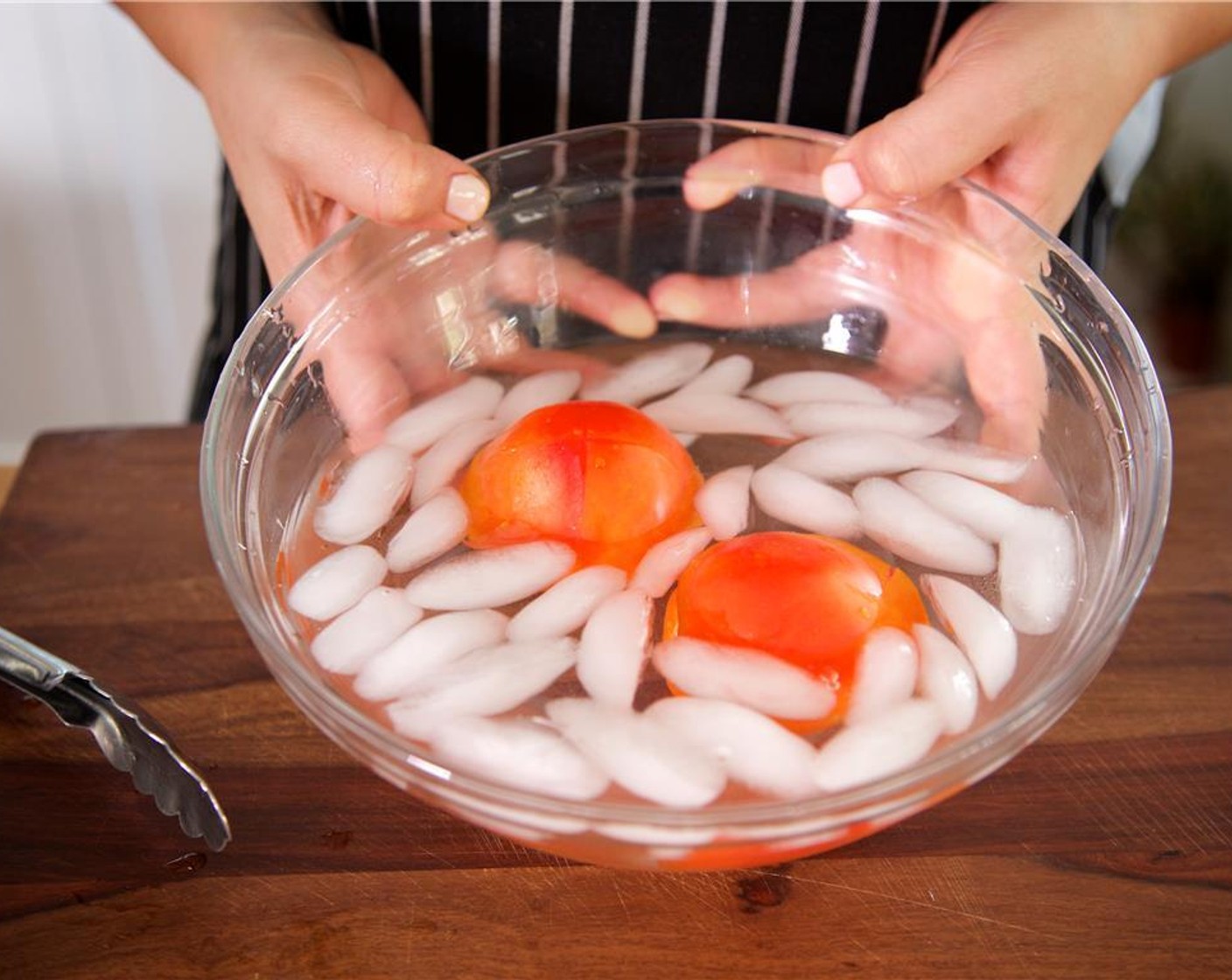 step 9 Cut a two inch x shape, centered on the bottom end of the Tomatoes (2). Place the tomatoes in the boiling water for thirty seconds and transfer to ice water.