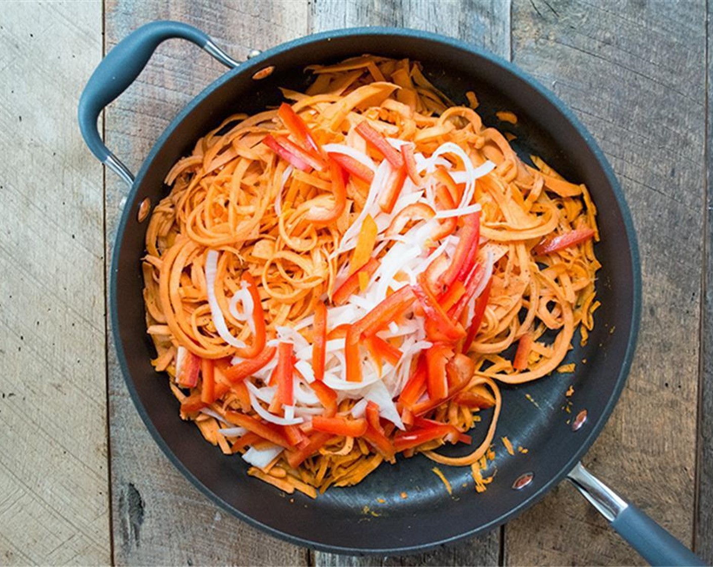 step 6 Add sliced red bell pepper and onion to the pan and cook an additional 5-7 minutes or until veggies are tender, similar to the texture of cooked pasta.
