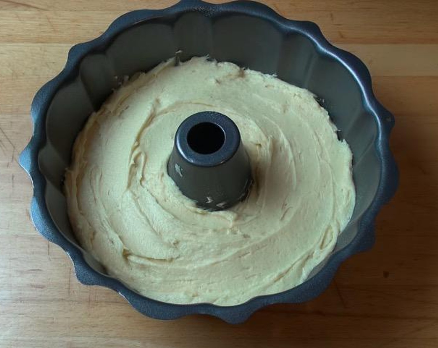 step 4 Transfer the batter into a lightly greased fluted bundt pan. Smooth the surface until even.
