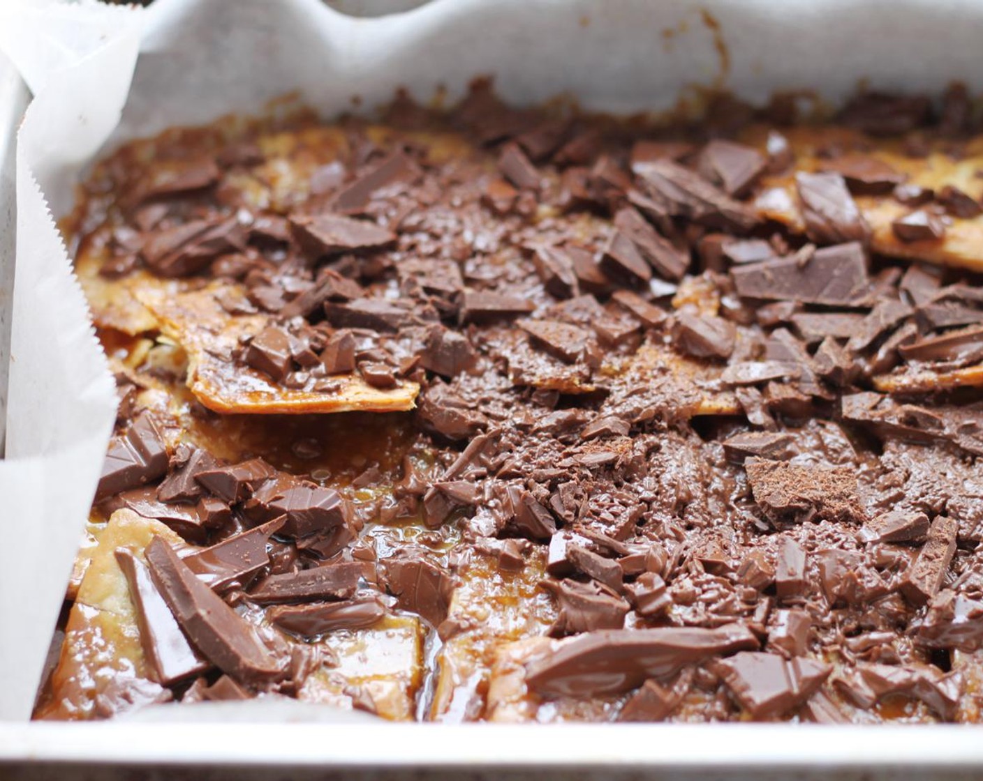 step 8 Remove the tray from the oven and evenly sprinkle over chopped chocolate. Leave it to melt for about 10 minutes.