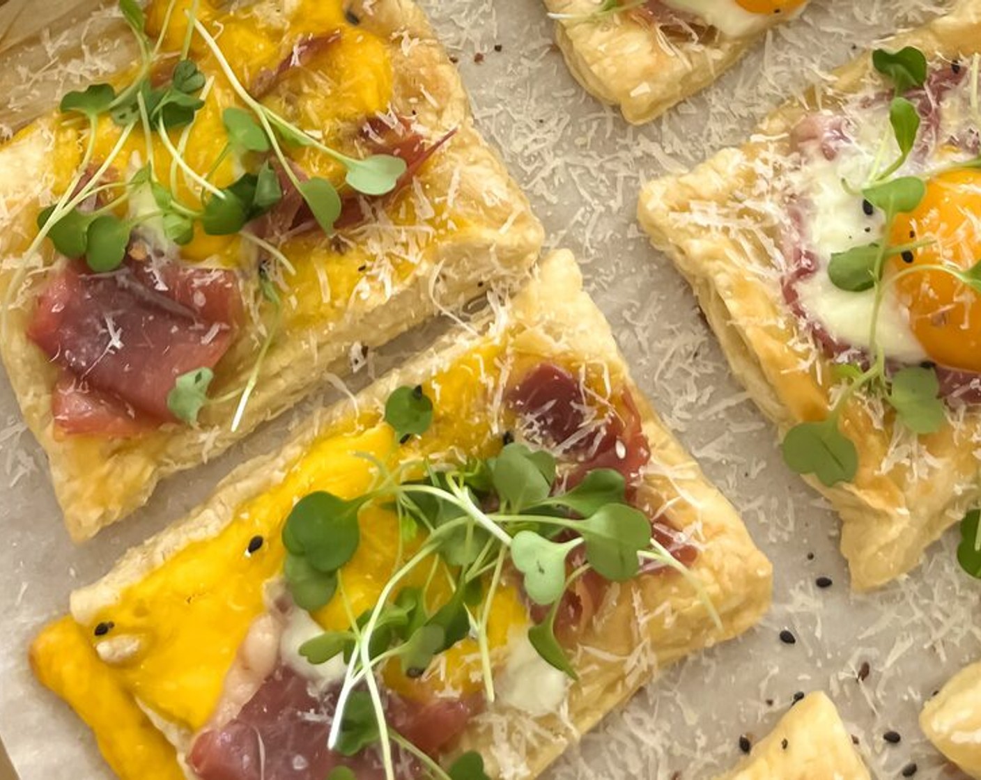 step 8 Finish with adding a handful of grated Parmesan Cheese (1/2 cup) and Microgreens (1 cup) on top of each tart.