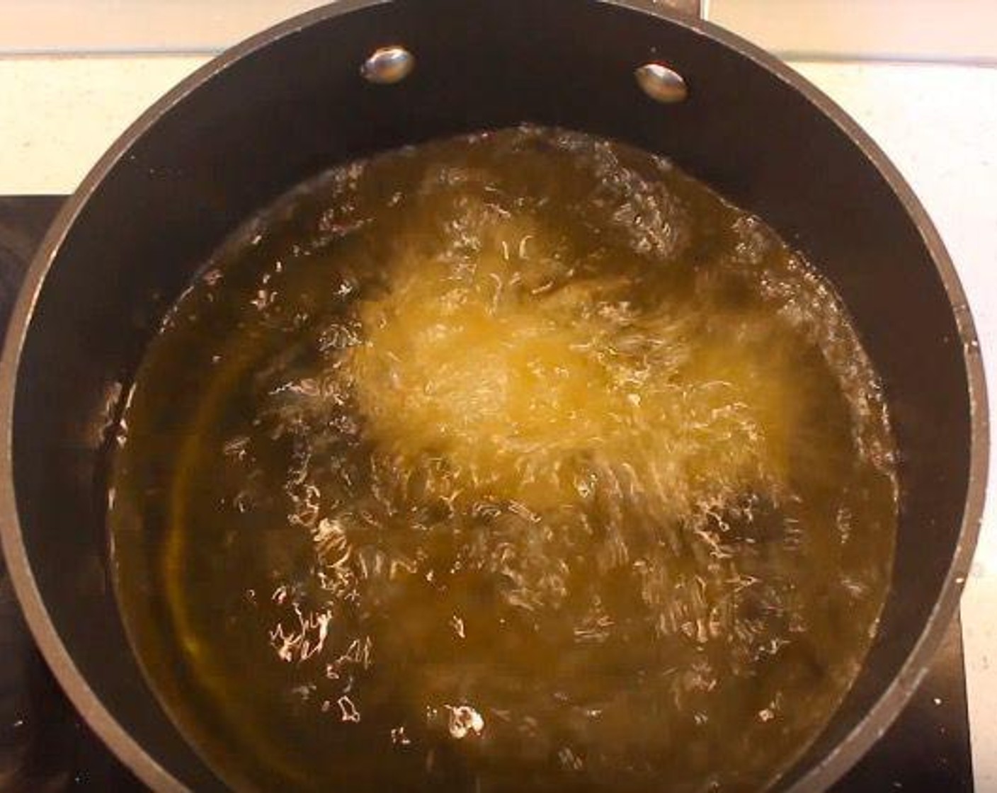 step 5 Heat Frying Oil (as needed) in a pot. Fry chicken for 8 minutes, placing finished pieces on a paper towel.