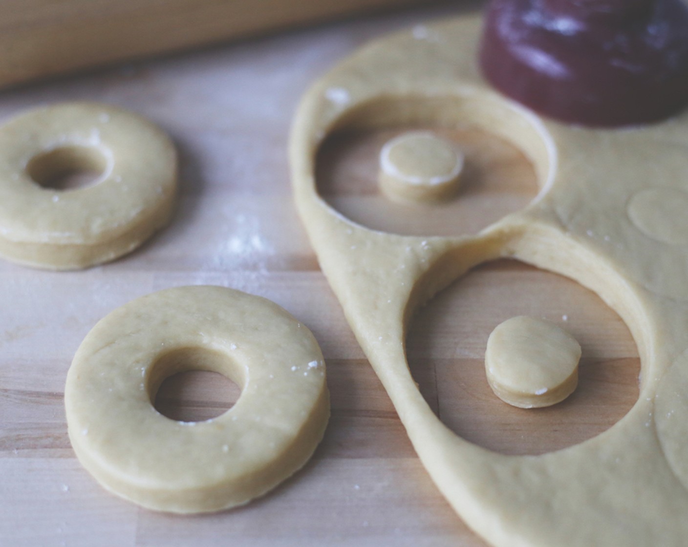 step 13 Using a doughnut cutter or round cookie cutter, cut out doughnuts and place on a lined baking tray. If you have any leftover dough, re-roll and continue cutting if need be.