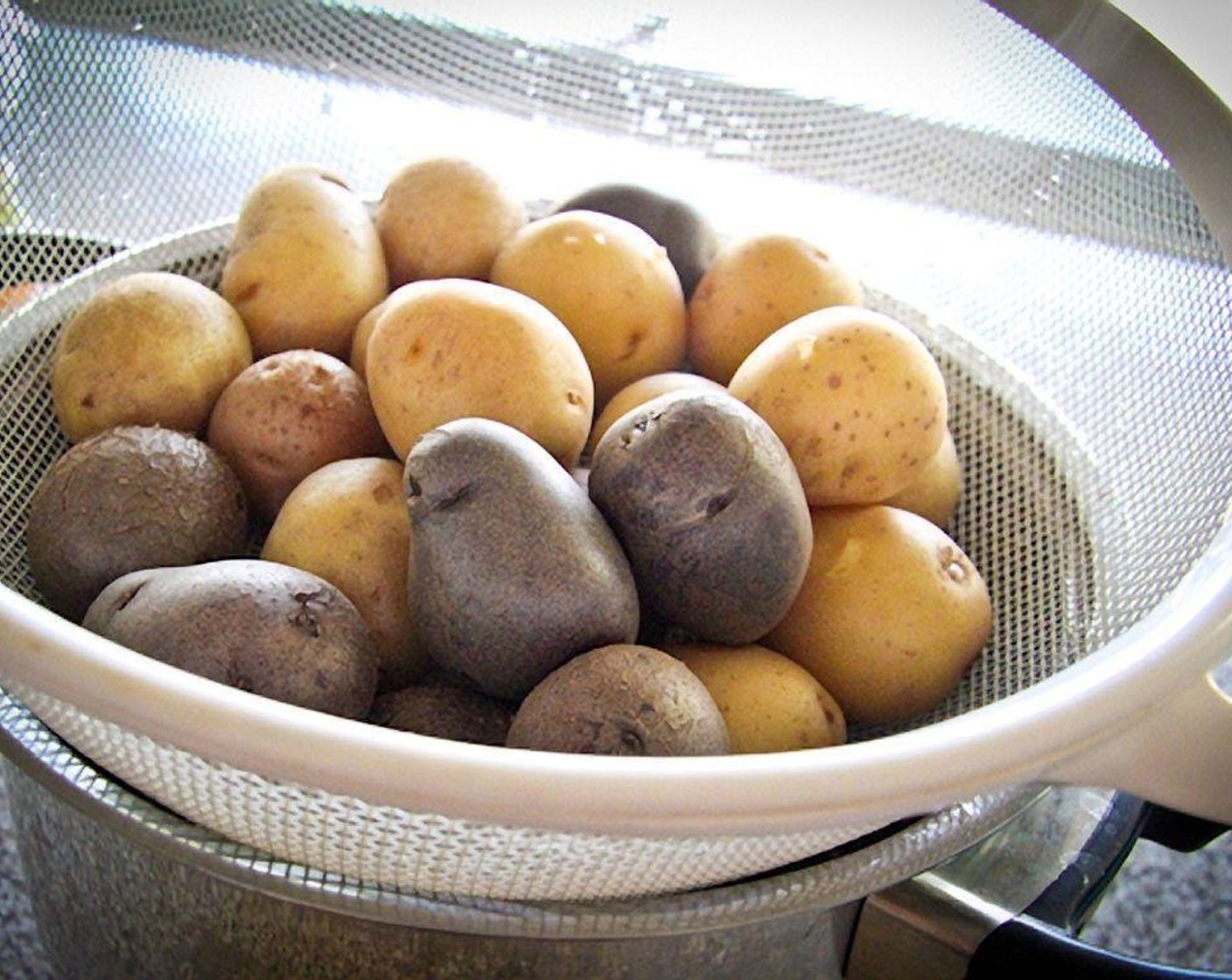 step 4 Drain the potatoes in a coriander, and place it on top of the hot pot you just used to cook the potatoes, to dry them out slightly.