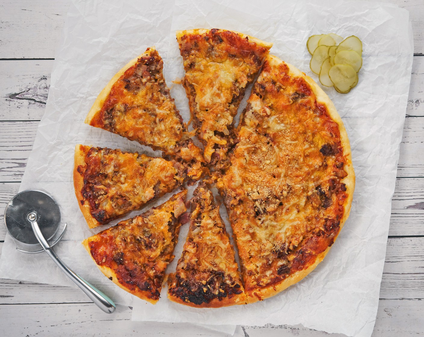 step 9 Slice with a pizza cutter. Sprinkle the top with Lettuce (to taste), Dill Pickles (to taste), and Tomatoes (to taste). Serve immediately!