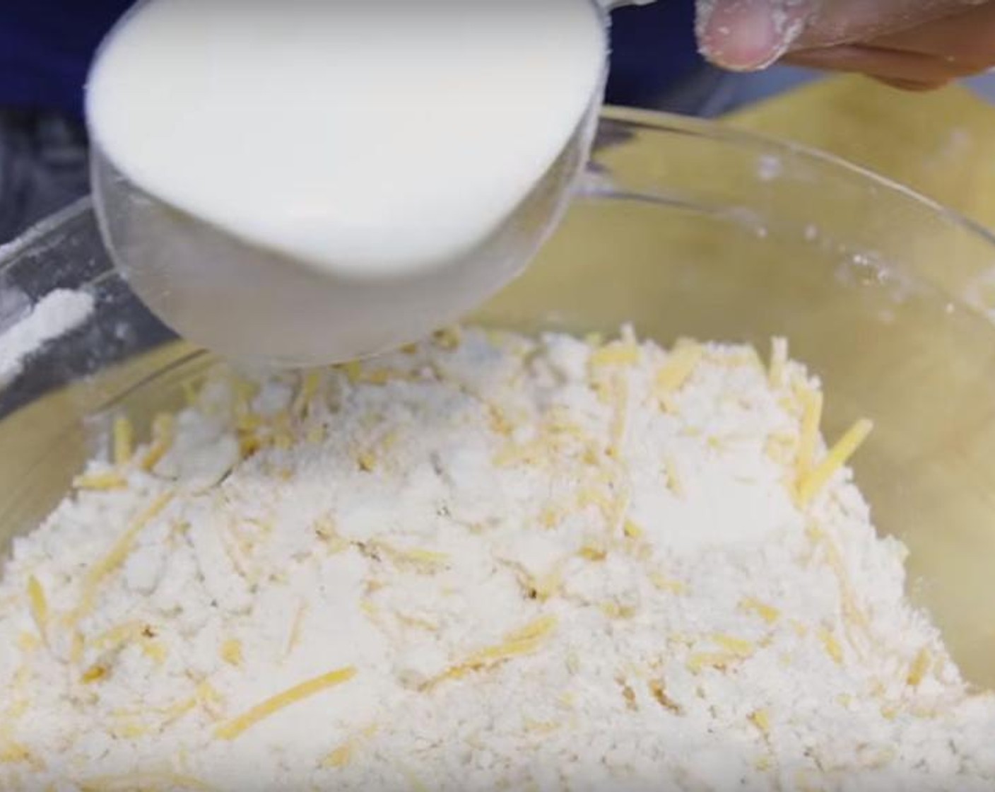 step 2 In a large bowl, whisk All-Purpose Flour (3 cups), Caster Sugar (1 Tbsp), Baking Powder (1 tsp), Baking Soda (1 tsp), Salt (1 tsp) and Simply Organic Garlic Powder (2 tsp) until combined. Add in the Butter (1 1/2 sticks) and using your fingers, rub it into the flour mixture until it resembles coarse meal. Add in the Cheddar Cheese (2 cups), then Buttermilk (1 1/2 cups) and mix until combined.