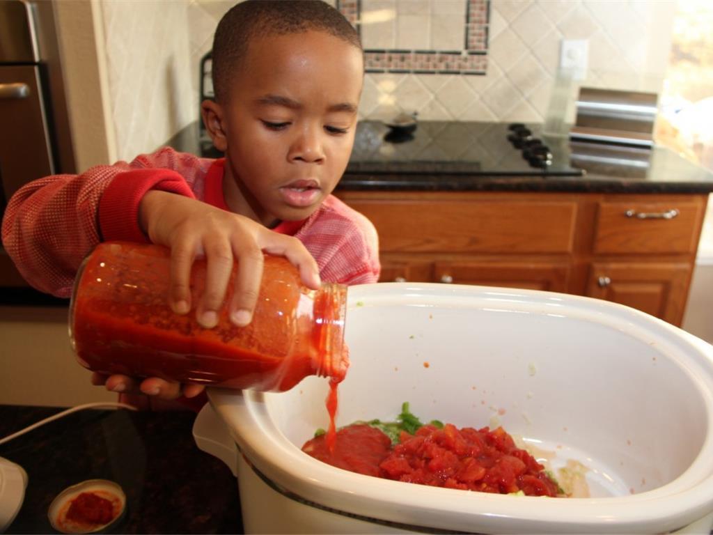 Step 4 of Pizza in a Bowl Recipe: Add the veggies, the Canned Diced Tomatoes (14.5 ounce), Water (1 cup) and Marinara Sauce (26 ounce) to the slow cooker.