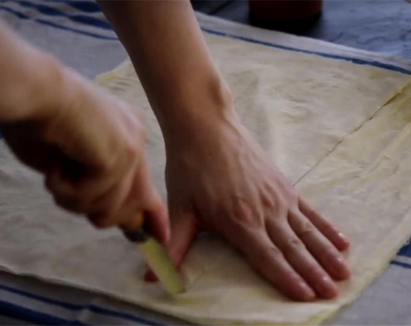 step 3 Place the Phyllo Dough (1) with the long side horizontal and shorter side vertical and slice into 4 equal strips. Cover with a damp tea towel so the pastry does not dry out.