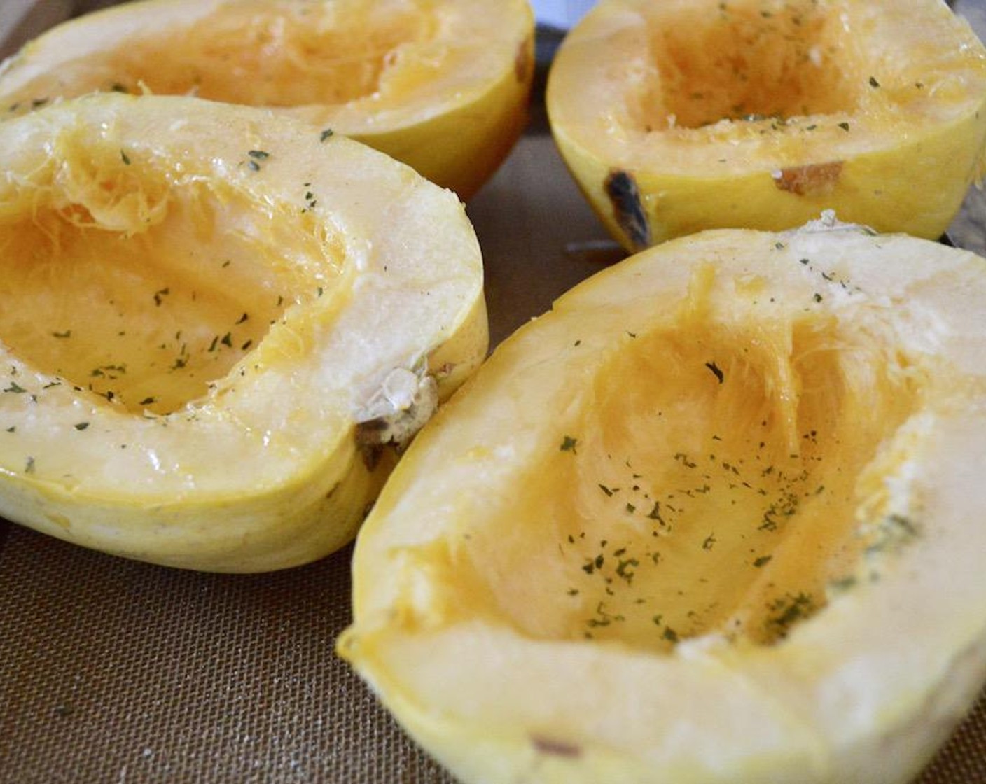 step 2 Cut each of the Spaghetti Squash (2) in half lengthwise to form 4 little boats. Scrape the seeds out of each half. Drizzle the flesh in each half generously with Olive Oil (as needed), followed by Salt (to taste), Ground Black Pepper (to taste), McCormick® Garlic Powder (to taste), and Dried Parsley (to taste). Roast the squash for 45 minutes to make it tender and shreddable.