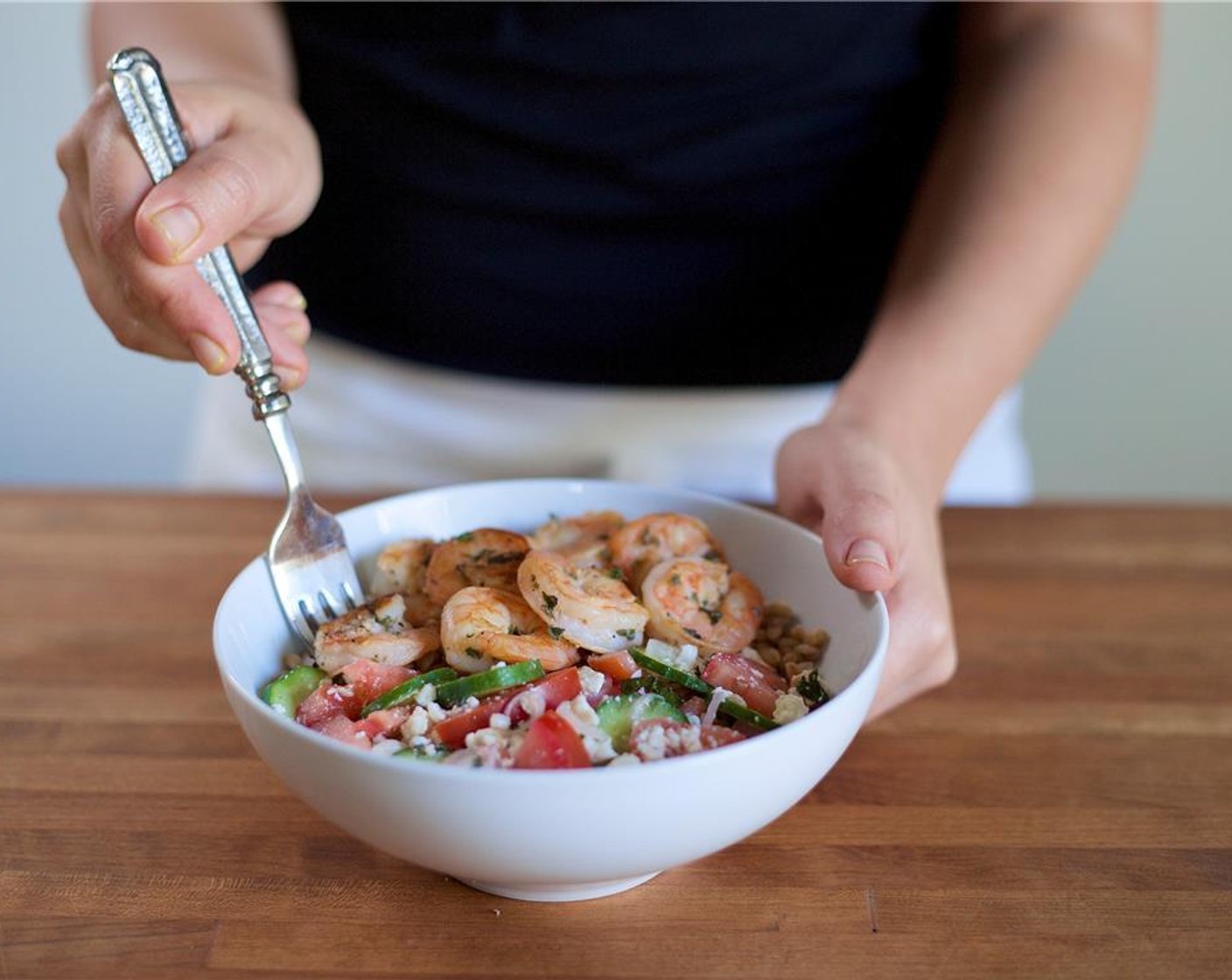 step 9 In the center of two bowls place the farro. Top with tomato and cucumber salad. Place the shrimp next to the salad.