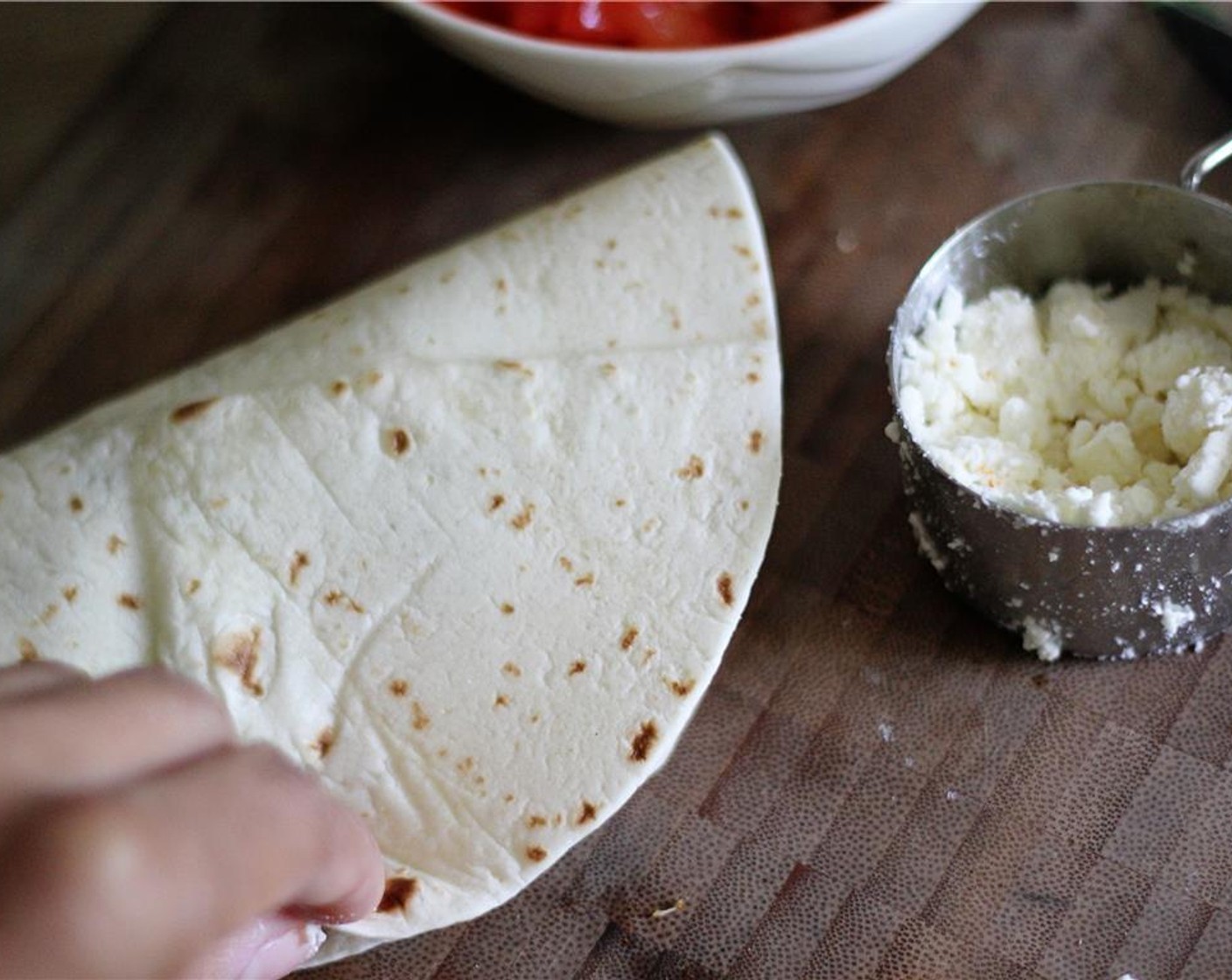 step 4 Then fold in half pressing gently. Warm about a teaspoon of olive oil in a large skillet. Cook quesadillas over medium heat for about 4-5 minutes or until golden brown flipping once. Remove from skillet, set aside and keep warm.