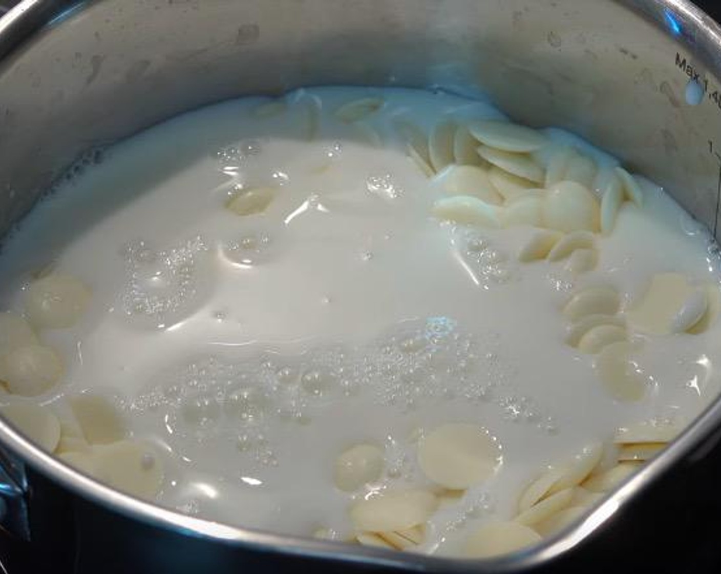 step 2 In a small saucepan on low heat, combine White Chocolate (1 cup) and Milk (1 1/2 cups). Stir until the mixture is smooth. Set aside to cool.