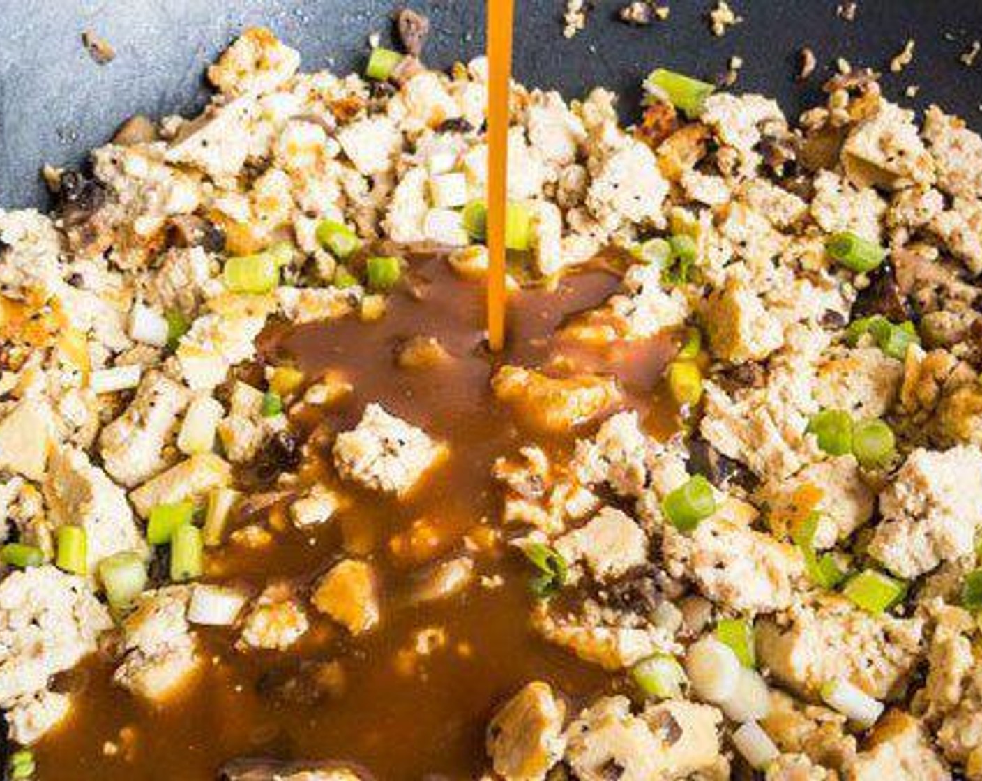 step 6 Add Scallions (3 stalks). Stir peanut sauce and pour over tofu mixture. Cook just a minute longer, being careful not to soak up all of the sauce.