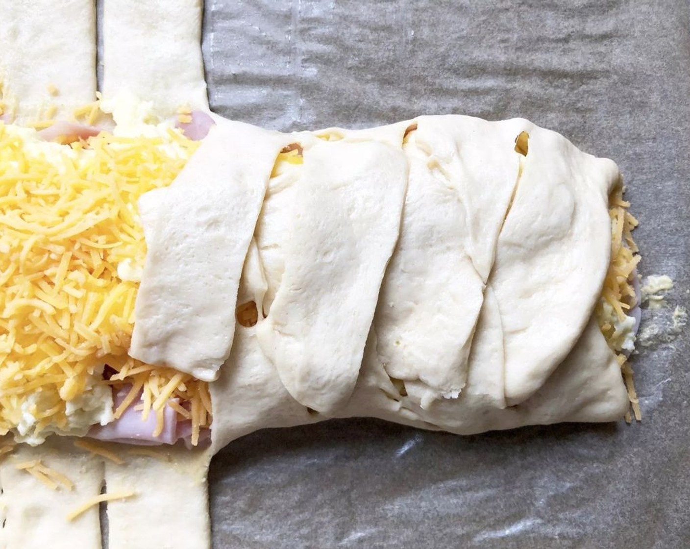 step 8 Crisscross the dough flaps over the filling to form a braid pattern.