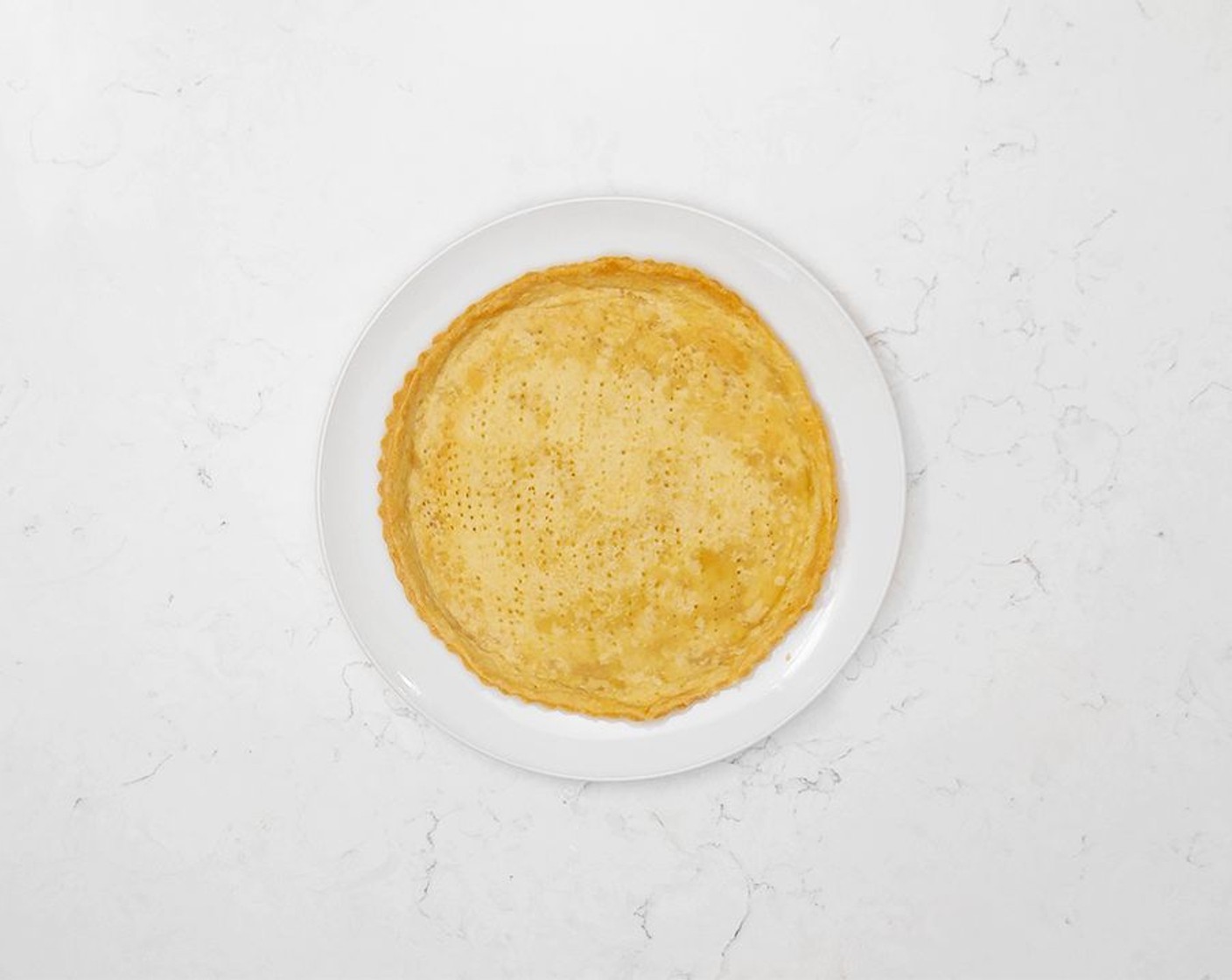 step 7 Using a fork, poke holes in the bottom of your crust. Careful not to pierce all the way through the dough. Prebake the crust for 10 minutes with pie weights before using as desired.