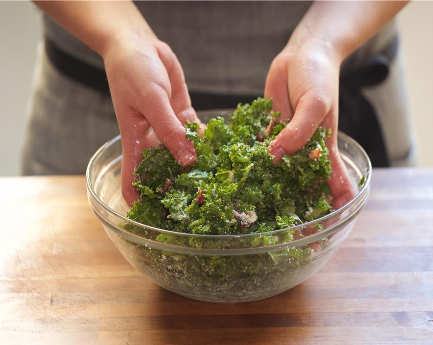 step 10 Meanwhile, in the same large bowl, add the vinaigrette, add the kale, bacon, crimini mushrooms, half of the Parmesan Cheese (1/4 cup), Salt (1/4 tsp) and Ground Black Pepper (1/4 tsp). Mix until well combined and fully incorporated.