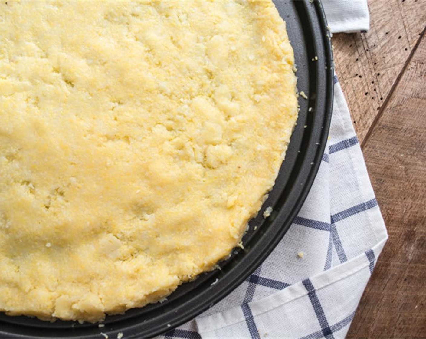 step 3 Add Polenta (1 pckg) and Coconut Oil (1/2 Tbsp) to a bowl and mix. Spread the polenta mixture out on the pan until it is approximately ⅓-inch thick and evenly covers the round pan.