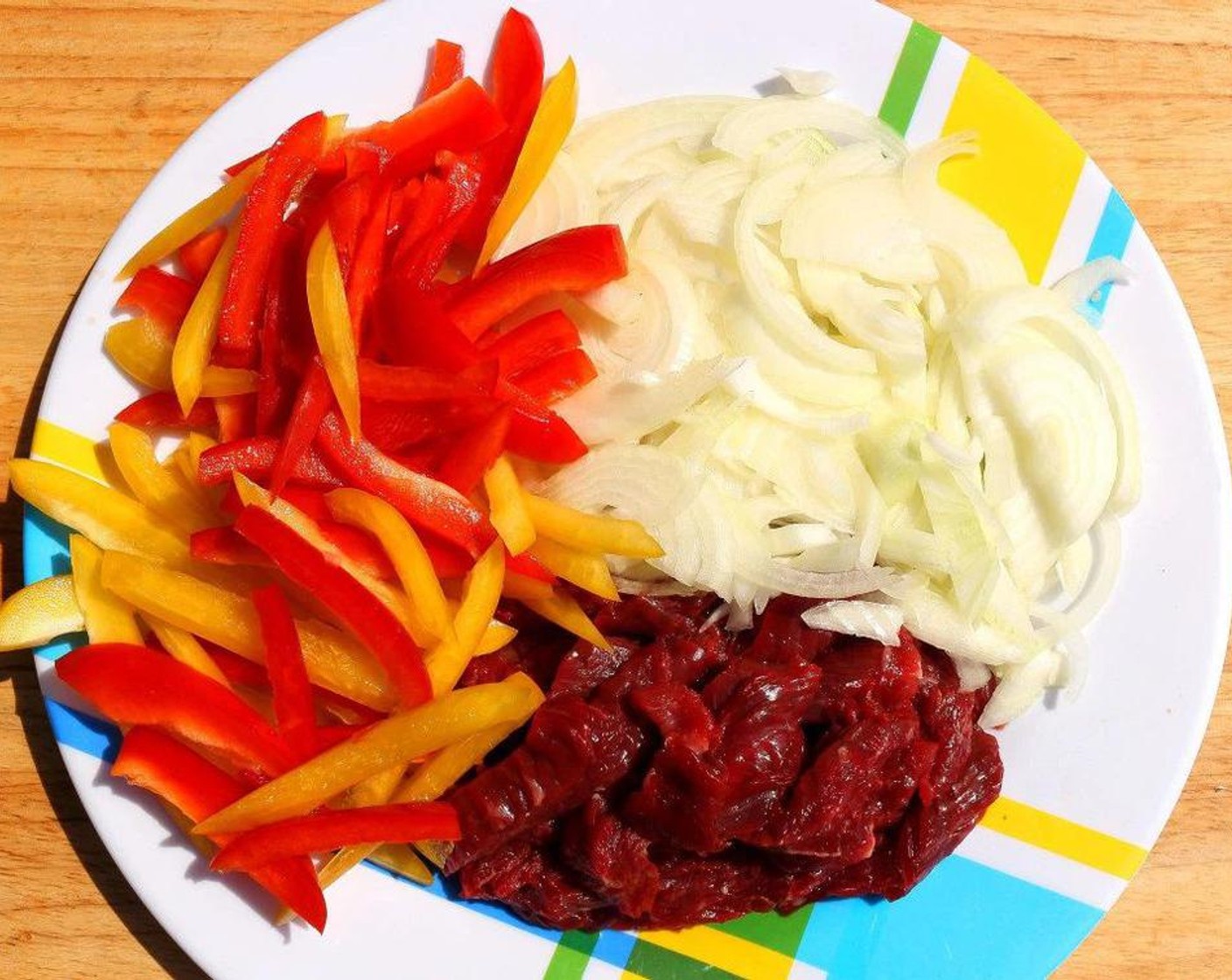 step 2 Cut up Red Chili Pepper (1), Orange Bell Pepper (1), and Onion (1). Combine with the beef.