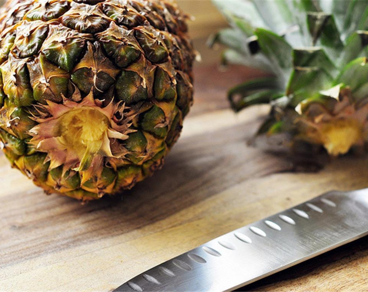 step 2 Prepare the Pineapple. To do this, cut off both ends of the pineapple so that it stands upright. Grab your knife, starting at the top, cut the peel away in one swift downward motion.