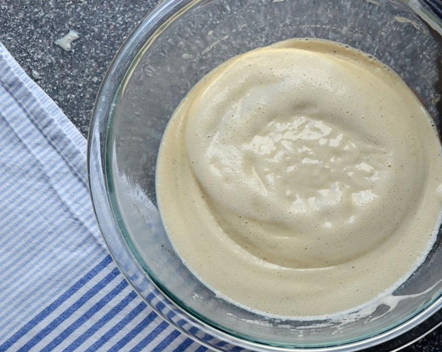 step 5 Set a strainer over a clean bowl and pour the eggs mixture through the sieve to remove any stray pieces of egg. Allow custard to cool slightly and stir in the Heavy Cream (1/2 cup), Vanilla Extract (1 tsp), and Dark Rum (1/3 cup).