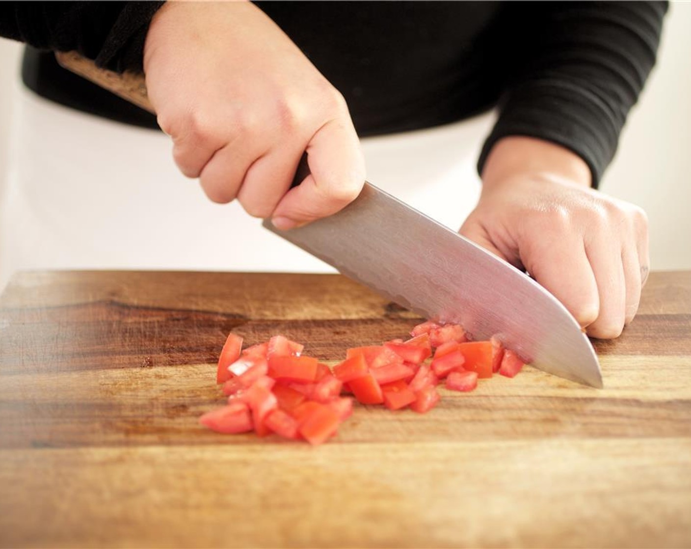 step 5 Cut the Roma Tomatoes (2) lengthwise into four wedges. Scoop out the seeds and discard. Slice tomato into thin strips, then into half inch diced pieces. Set aside.