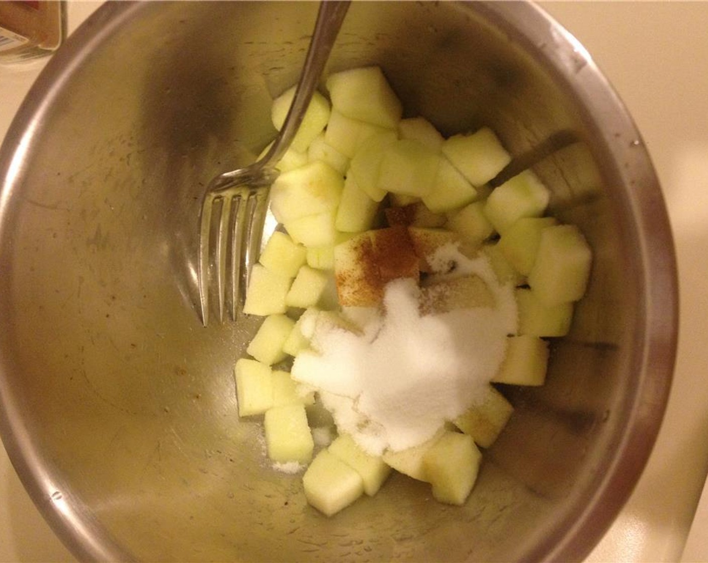 step 9 Heat the Unsalted Butter (1 1/2 Tbsp) in a pan. Combine diced apples with Lemon Sugar (1 Tbsp), Simply Organic Cinnamon, Ground (1 tsp), and Granulated Sugar (2 Tbsp) to prevent oxidizing.